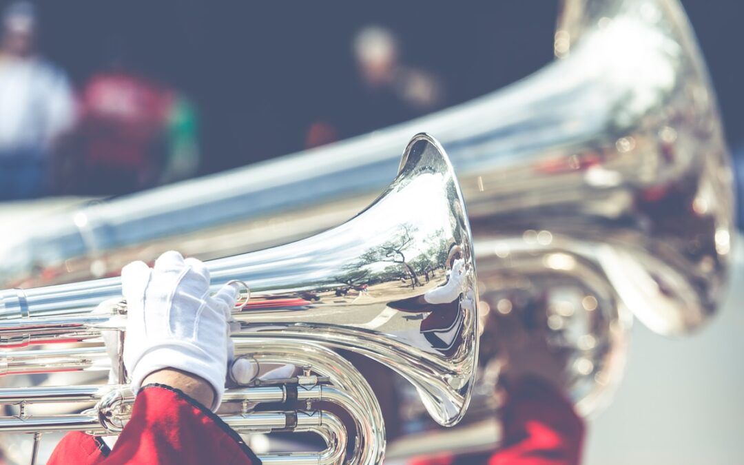 close up photo of person playing horn instrument