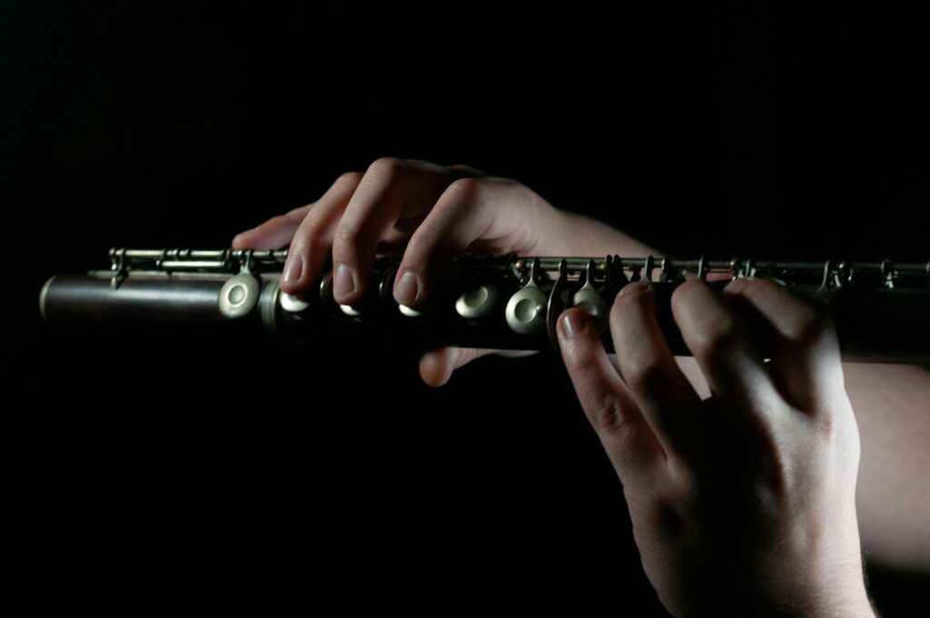 a person playing a flute in the dark