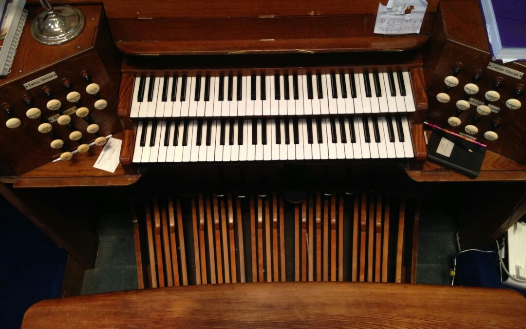 brown wooden upright piano with black and white piano keys