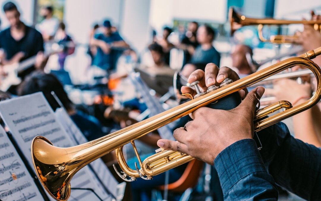person playing gold trumpet