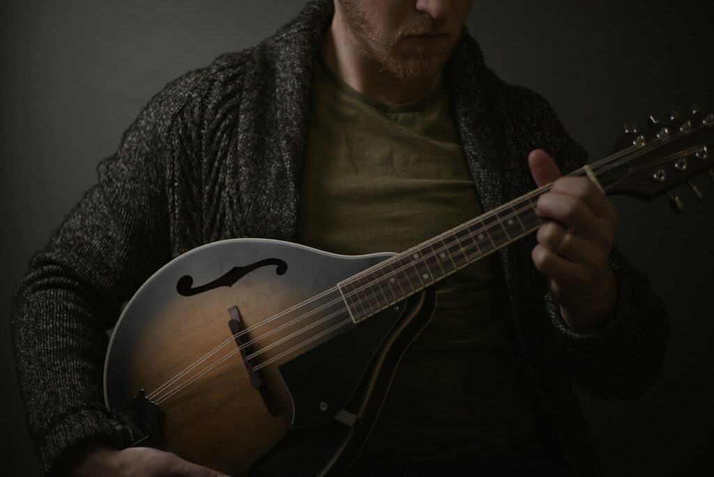 a man holding a guitar in his hands