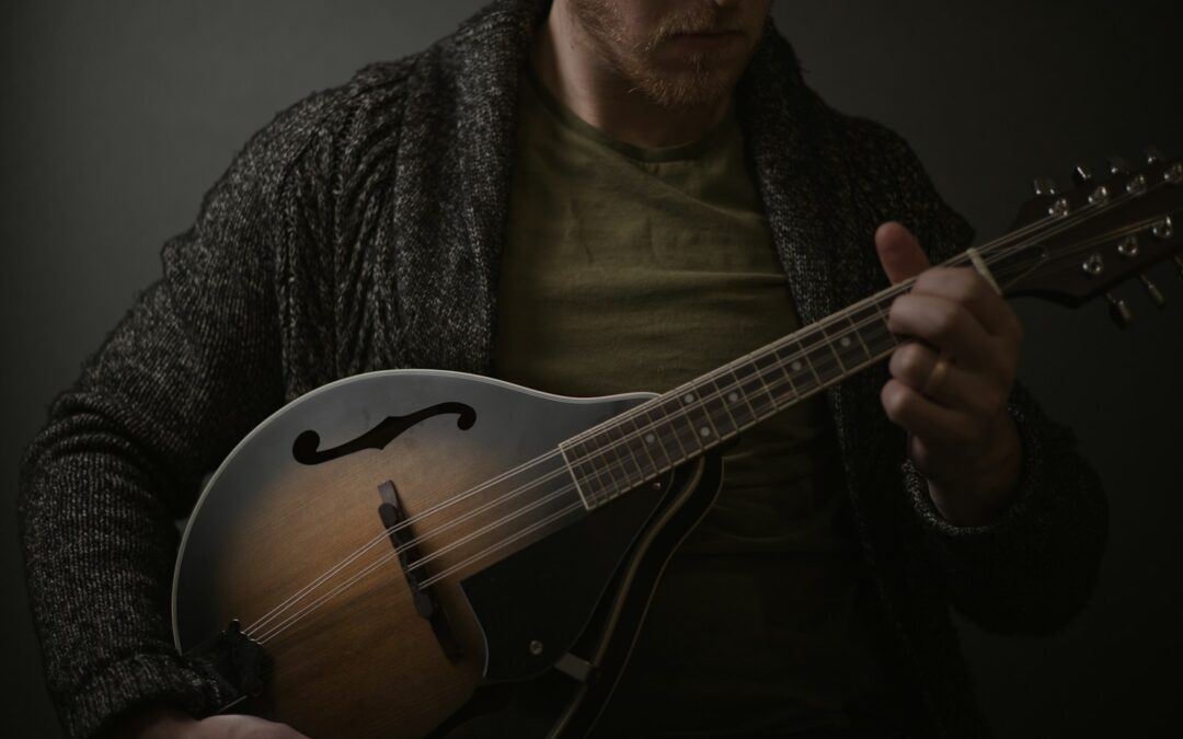 a man holding a guitar in his hands